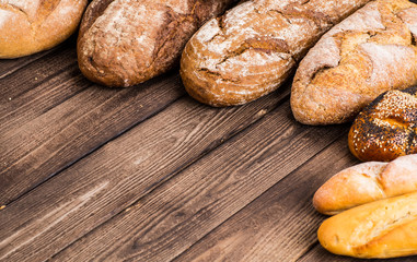 Many mixed breads and rolls shot from above.