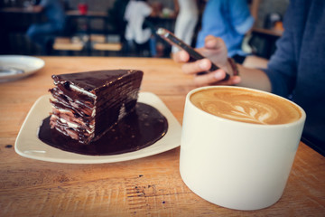 Coffee cup and chocolate cake on wood table  background woman us
