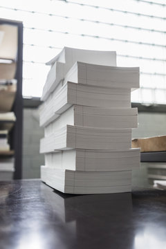 Stacks of paper on table