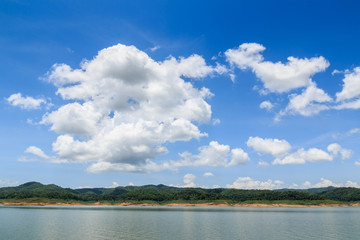 Fototapeta na wymiar blue sky with white clouds and river