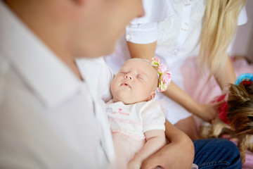 Babygirl sleeps on father's arms