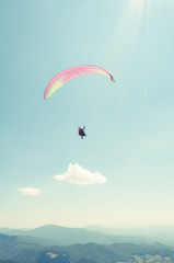 Paraglider in the sky in sun light
