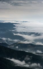 Foggy Landscape in mountains. A view from mountains to the valley covered with foggy landscape.