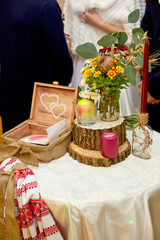 Tree blocks and yellow bouquets stand on the white table