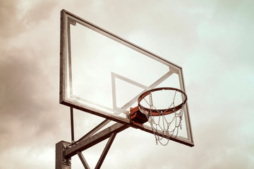 Basketball hoop against a rainy sky