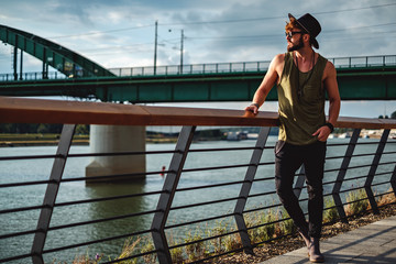 Hipster looking far away while standing by the river