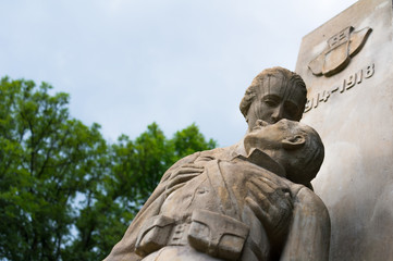 Fototapeta premium Pieta from first world war - mother / wife is mourning and holding dead body of son / husband. Memorial for killed soldiers on cemetery in Petrvald, Czech Republic