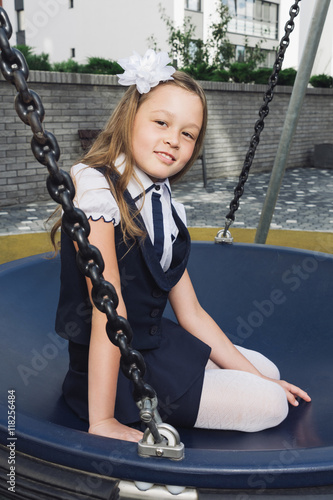 Cute Elementary Schoolgirl In Uniform At Playground Schoolgirl In A Darkly Blue Skirt And A