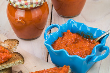 Roasted red pepper spread in blue bowl.