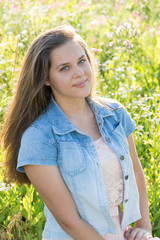 Beautiful teen girl in meadow in summer