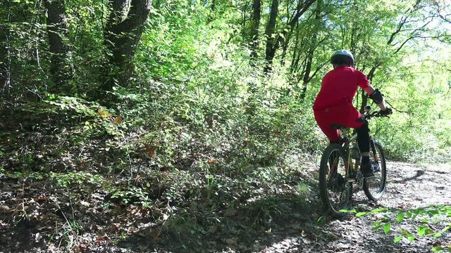 Mountain biker ride fast a downhill course in the forest