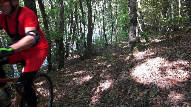 Mountain Bike traveling fast along autumn leaves forest track, crane 