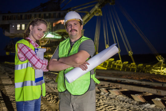 two workers stand on background of career stacker
