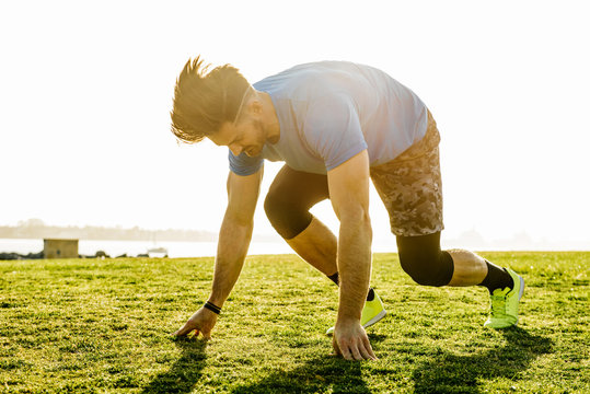 Man training, on his marks on coast, downtown San Diego, California, USA