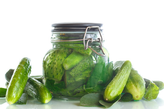 pickled cucumbers with spices in glass jar