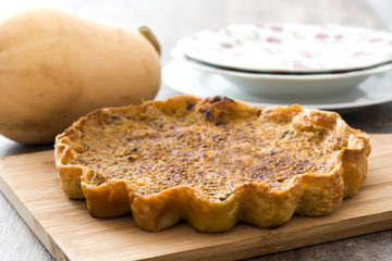 Homemade pumpkin pie on wooden background


