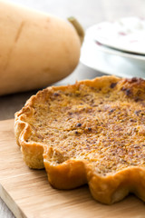 Homemade pumpkin pie on wooden background

