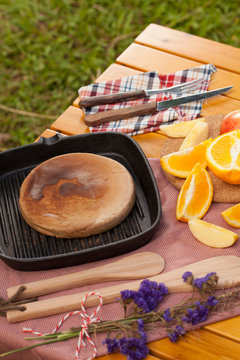 picnic, view of picnic table with various fruits, juice, pancake, coffee and vegetable at the camping area.