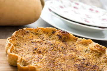 Homemade pumpkin pie on wooden background

