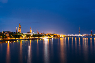 Cityscape At Evening Of Riga, Latvia. Night View With Blue Sky. 