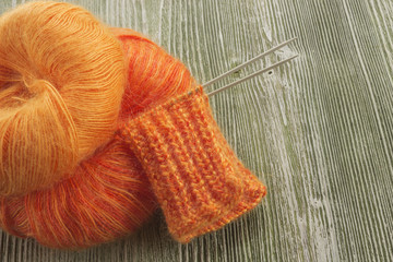 Fototapeta na wymiar Knitting orange mohair wool