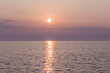 Beautiful sunset colors in the sky by the sea in summer