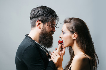 sexy couple eating red strawberry