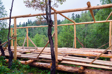 Fototapeta na wymiar Installation of wooden beams from logs