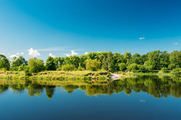 Summer River Landscape With Green Forest Woods On Coast And Reflections