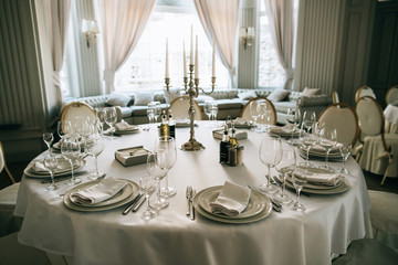 Elegant wedding reception white table arrangement restaurant, 
candlestick on table
