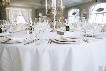 Elegant wedding reception white table arrangement restaurant, 
candlestick on table