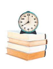 Stack of old books with clock