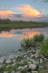 river with a rocky coast at sunset