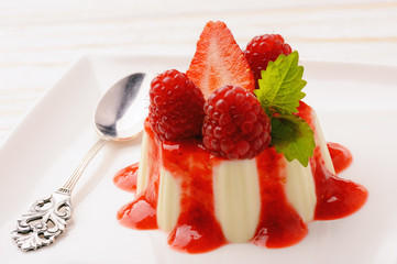 Panna cotta with strawberry mousse and raspberries.