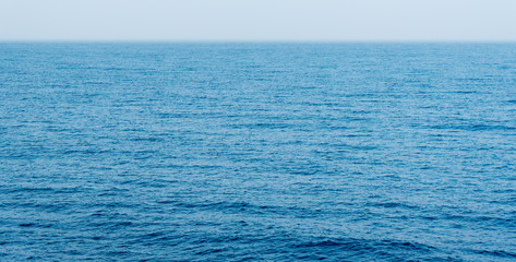 Fototapeta na wymiar Sea or ocean calm blue water surface