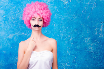 Comic image with female / women / adult with pink wig and black mustache on blue background