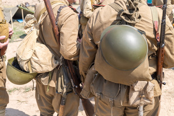 two Soviet soldiers with knapsack and helmets behind