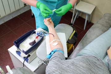 doctor sets the catheter to donor who give blood