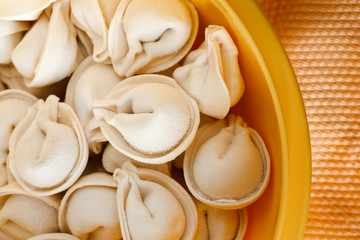 fresh frozen ravioli on a yellow background