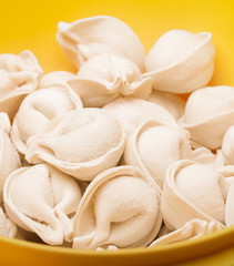 fresh frozen ravioli in a yellow plate closeup