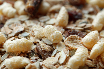 Fototapeta na wymiar Healthy breakfast from a dry muesli, raisins and oat flakes. Food made of granola and muesli.