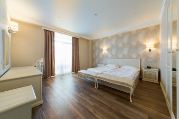 Interior of a hotel room with beds and table in El Paraiso hotel