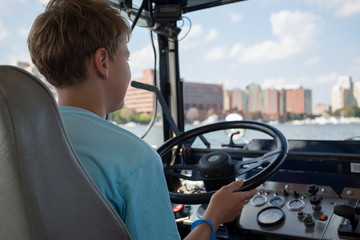 Back view of the boy is sitting at an amphibia car. © Pavel Losevsky