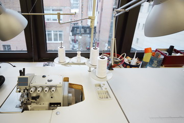 Modern sewing machine at table near window in workshop at British Higher School of Art and Design.