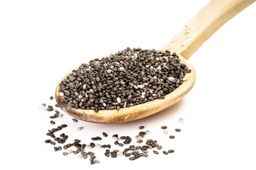 Chia seeds on a wooden spoon seen from the front on white background