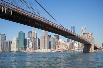 Fototapeta na wymiar Cityscape of Brooklyn Bridge across East River at autumn day.