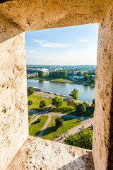View of modern part of Krakow and the river Visla through the opening in wall from Wawel castle Watchtower, Poland.