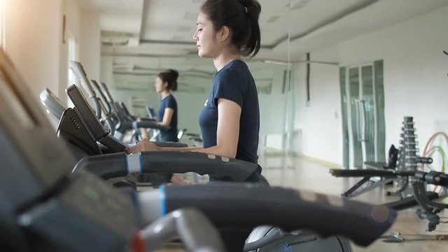 Asian Woman Walking,  Running On Treadmill Gym Workout.
