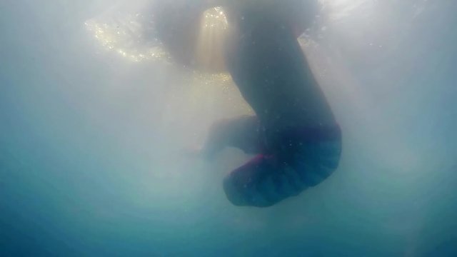 Small boy swimming with inflatable rubber SLOW MOTION. safety ring 