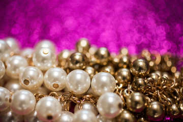 Jewelry background with white and golden pearls